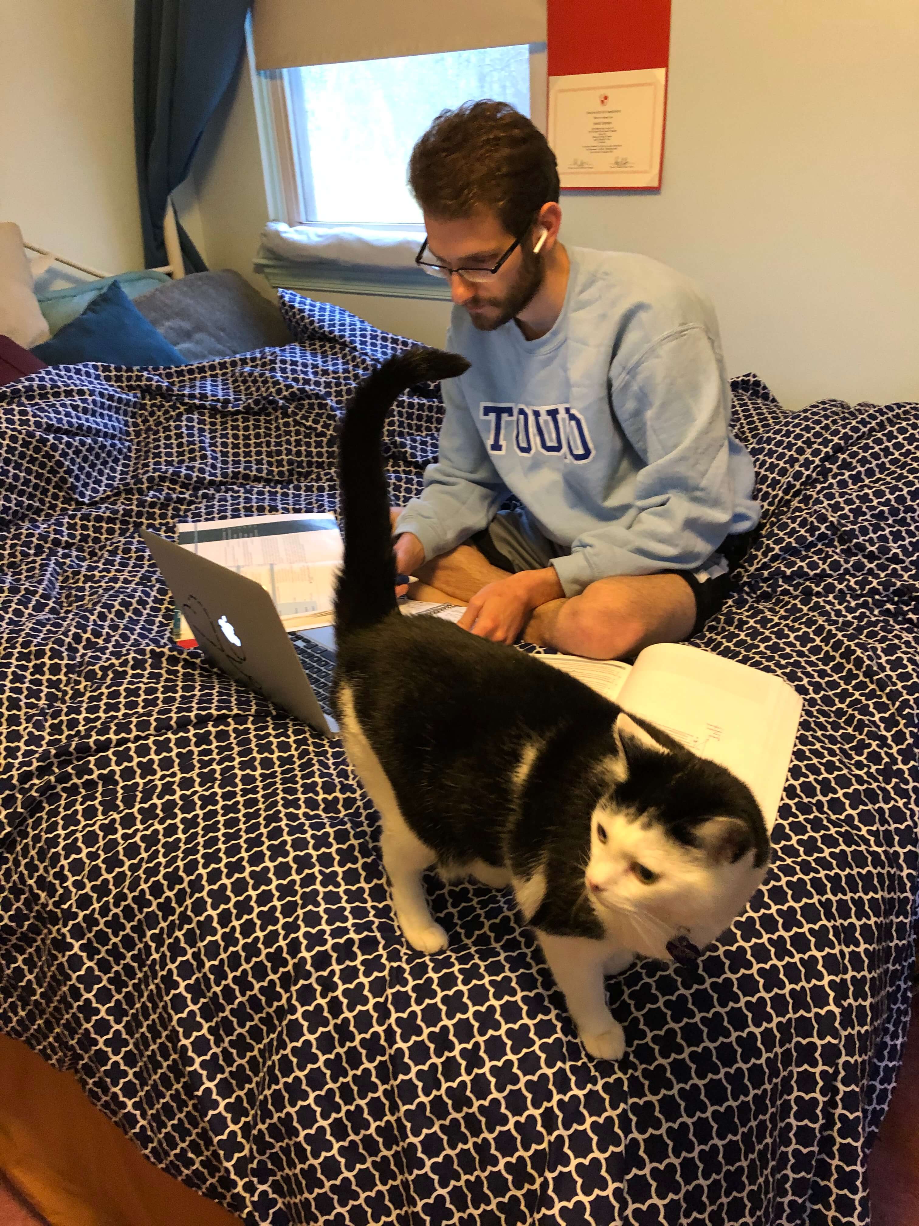Adam Halpern, OMS II, studying with Hilly the cat in Pennsylvania while school is closed for “Stay-at-Home” in New York