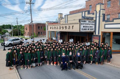 class of 2022 touro college of osteopathic medicine middletown standing in street wearing caps and gowns