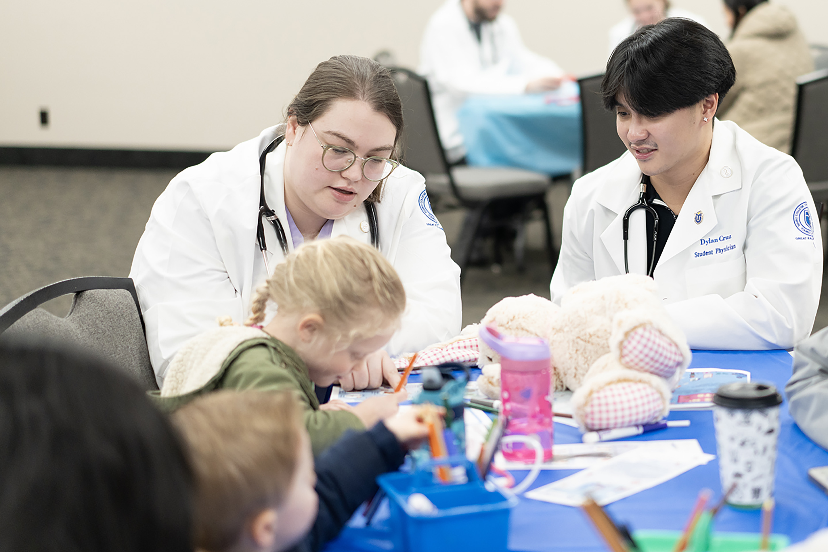 TouroCOM Montana medical students engage with young children at the Great Falls Public Library through the \'Docs N\' Tots\' program. 