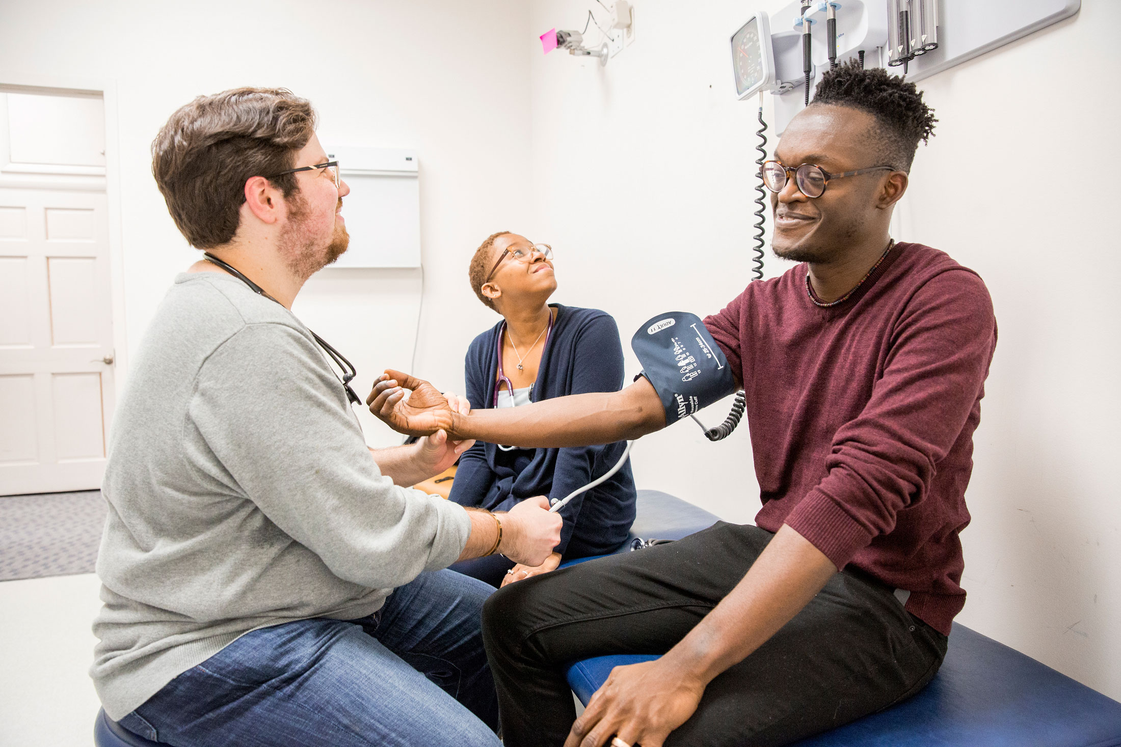 student taking another student's blood pressure