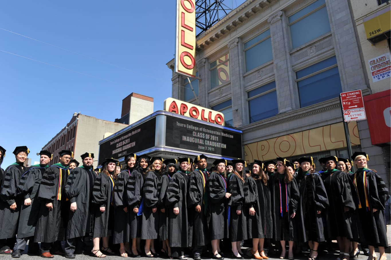 Class of 2011 graduates standing outside of the Apollo