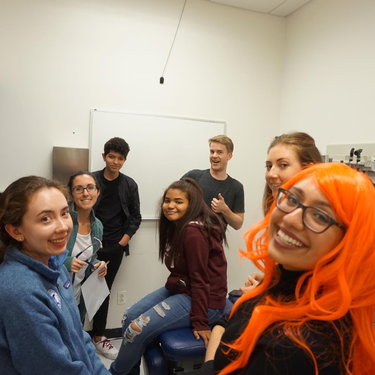 students posing in a model drs office