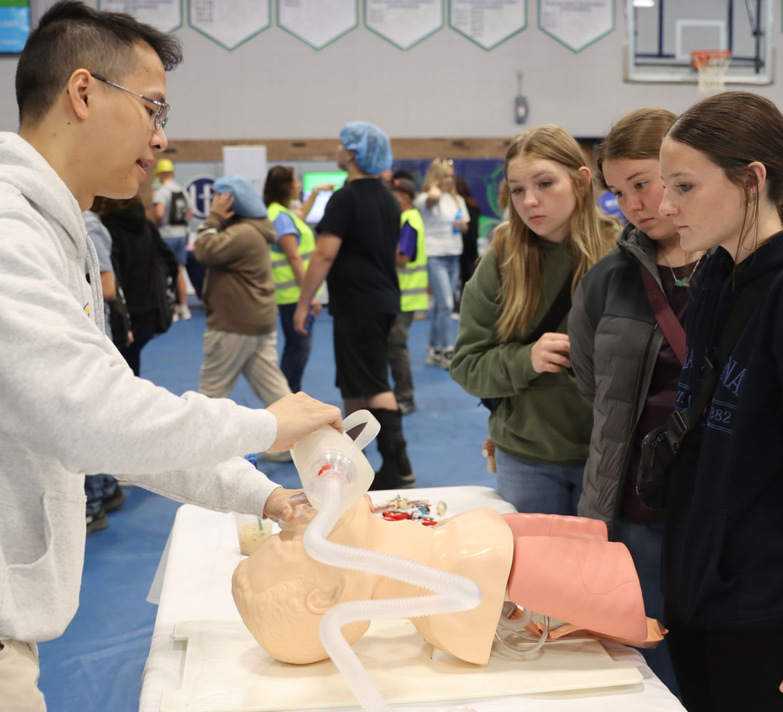 student teaching teenagers CPR at event
