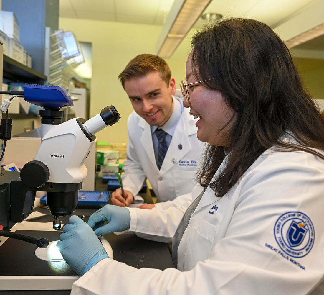 Two students researching together in lab