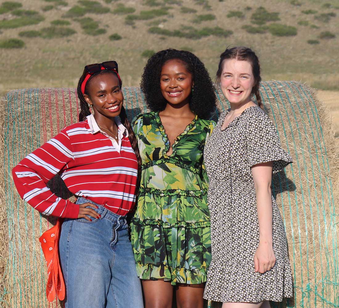 Three students smiling at the annual Touro hootenanny