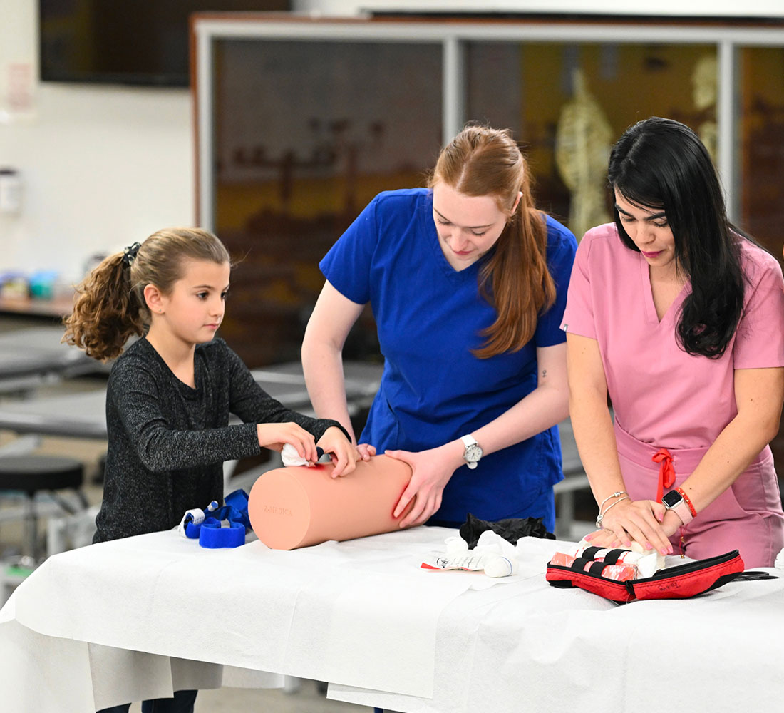 Students helping child learn skills
