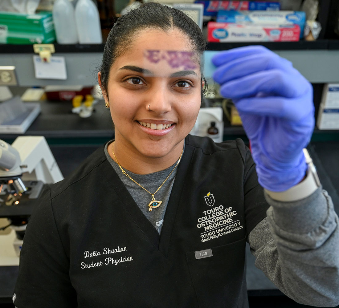 Student looking at sample in lab