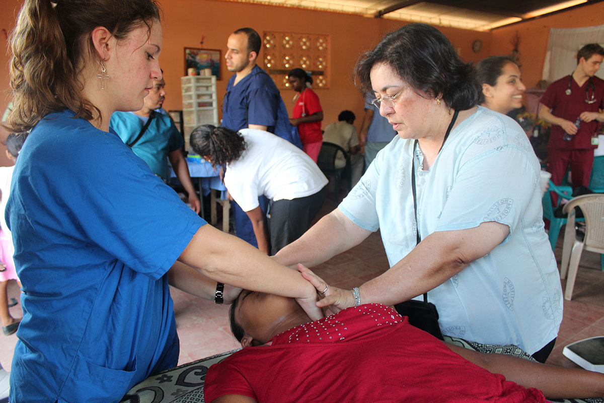 A TouroCOM student treats a patient