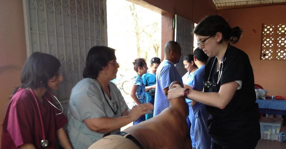 Gabrielle Rozenberg, right, performing OMM with the help of TouroCOM Professor Dr. Vasconez-Pereira (left) during a Global Medical Training mission in Nicaragua.