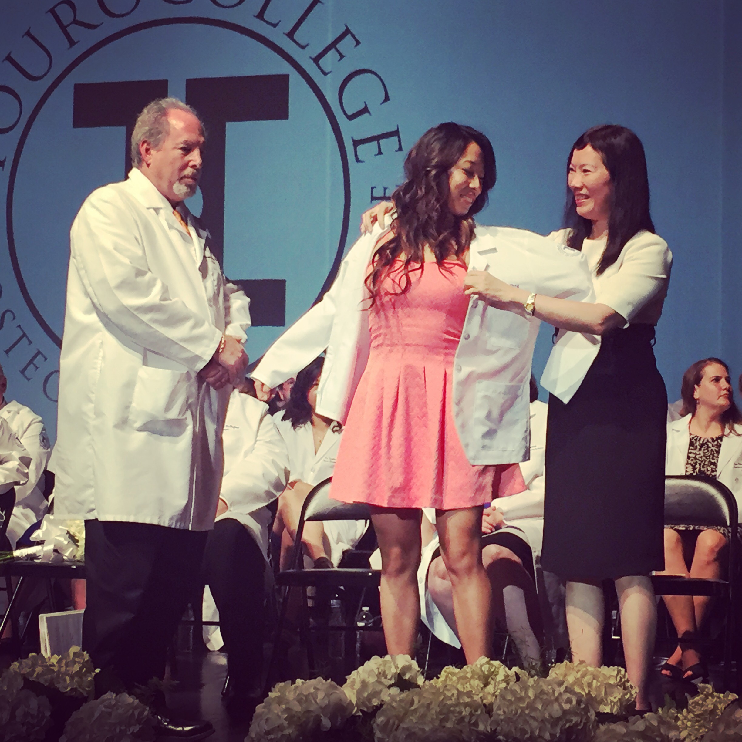Tina Yang, TouroCOM-Middltown Class of 2020, receives her white coat.