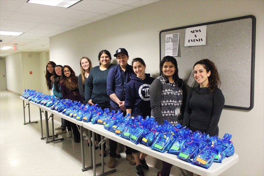 First-year Osteopathic Medical Students stand with their homemade care packages, ready to hand out to the second-year students.
