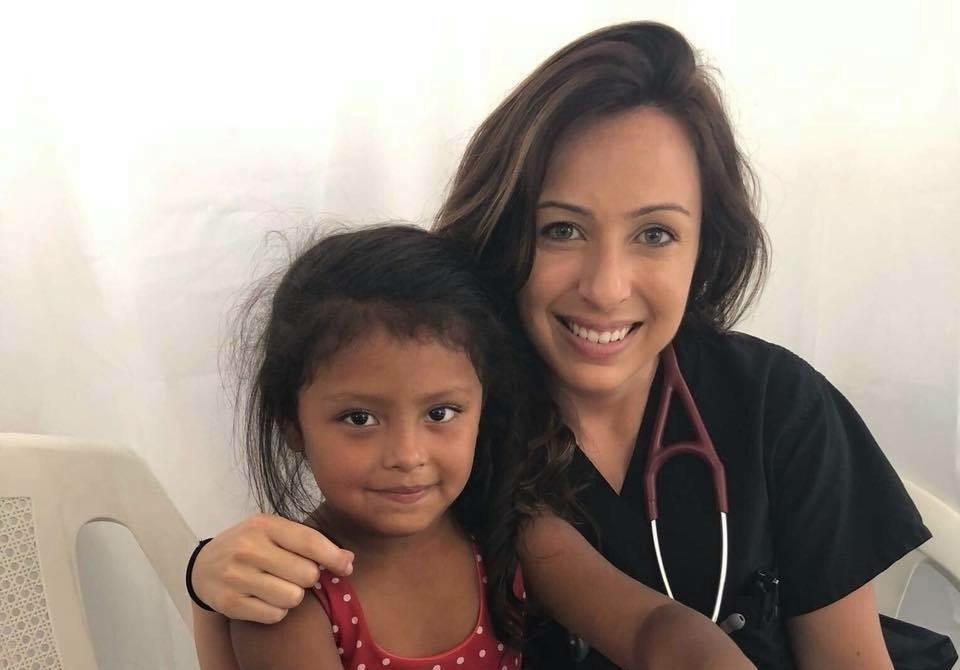 Touro student with a child.