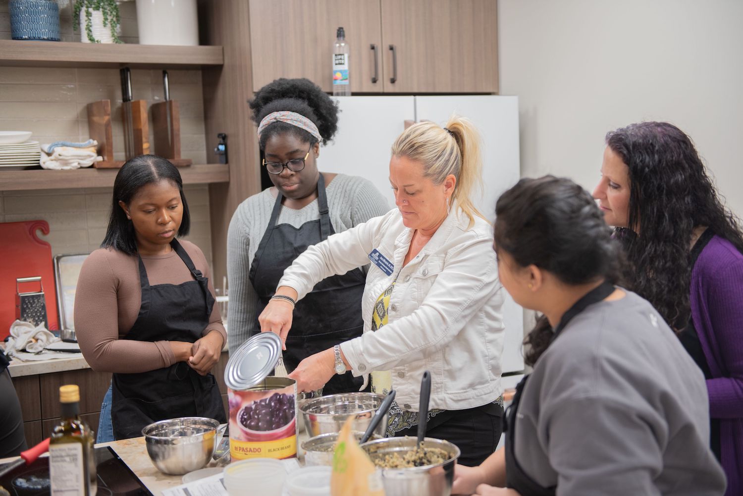 TouroCOM Montana students cooking in the Husted Teaching Kitchen