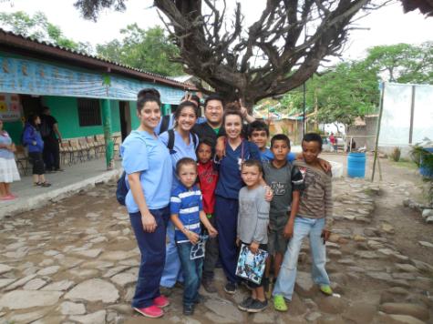 Students from TouroCom Middletown bond with Honduran children who received medical care.