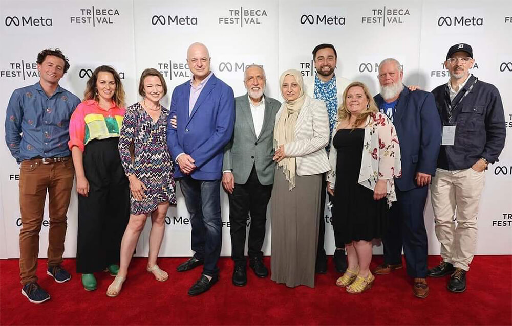 Dr Conrad Fischer (in royal blue jacket) with other people at the Tribeca Film Festival premiere of Strangers at the Gate