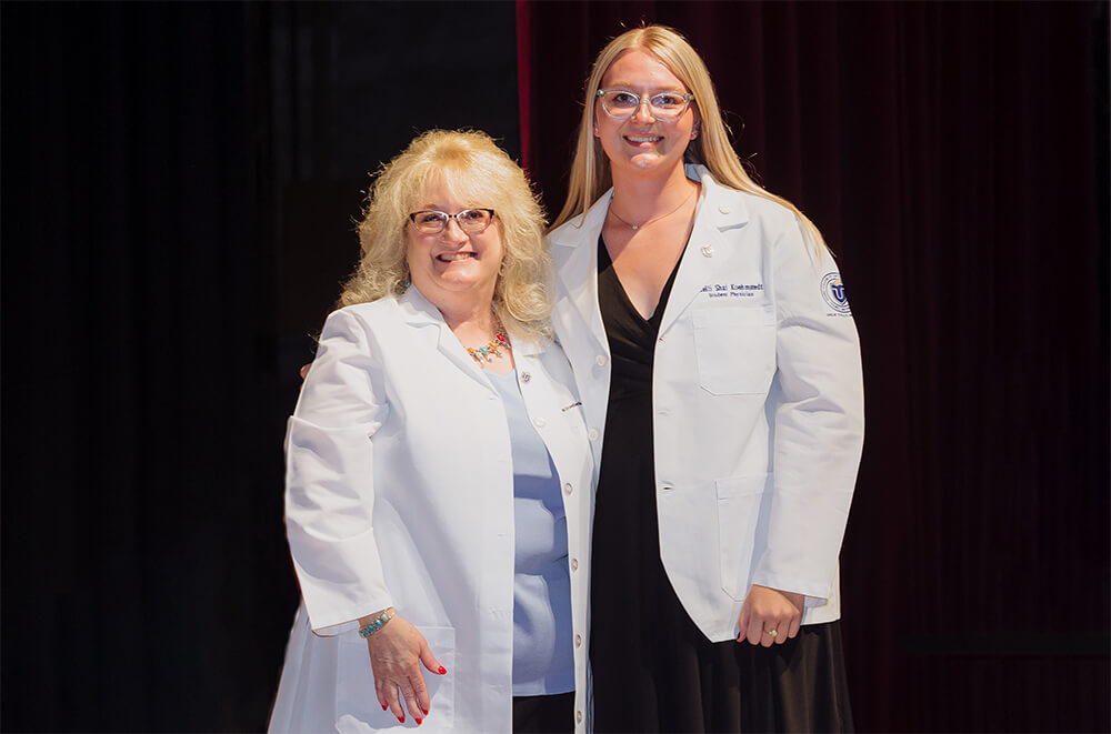 TouroCOM student Kelli Shai Koehmstedt with Dean Elizabeth Palmarozzi at White Coat Ceremony in Montana