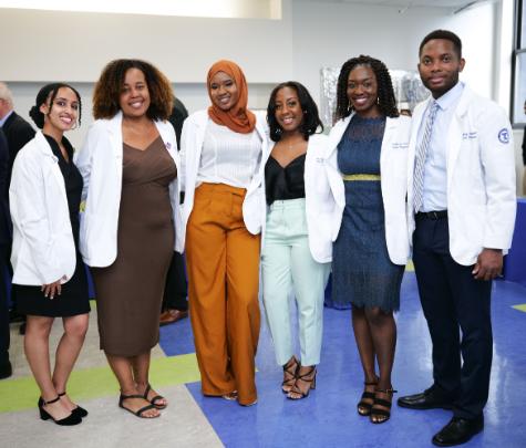 underrepresented minority medical students standing in a line at celebration  