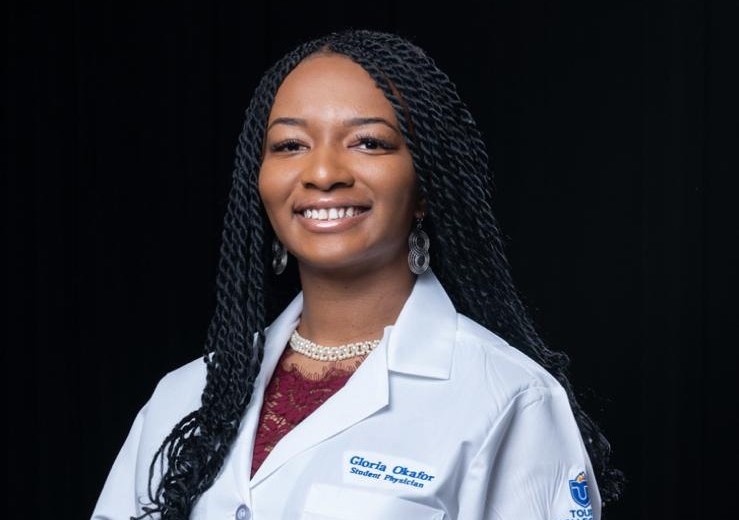 headshot of Gloria Okafor, MS, OMS-II in her white coat