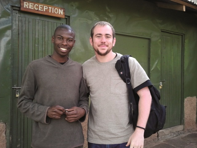 A TouroCOM student standing next to a man