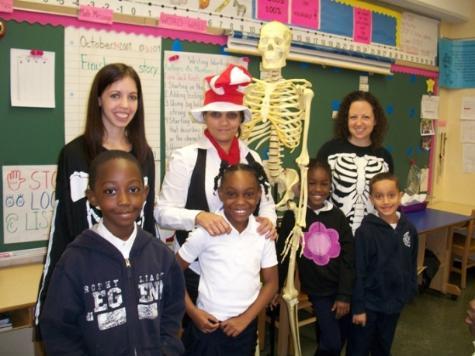 Sushama Rich, M.D. (center) and first-year students Jessica Abruzzino and Jacquelyn English with P.S. 180 students