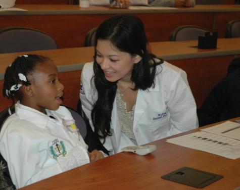 P.S. 197 student Taraajae Mitchell gets assistance from Touro College of Pharmacy student Myling Ta.