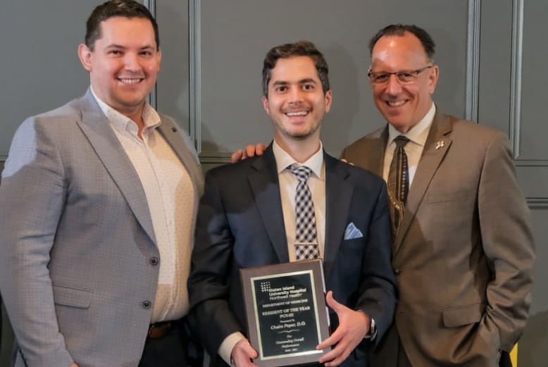 Chaim Poper posing with award